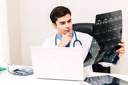 Doctor looking at x-ray photo in hospital.healthcare and medicineの写真素材