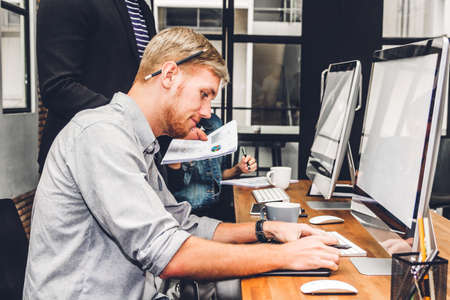 Group of casual business working and discussing strategy with desktop computer.creative business people planning and brainstorm in modern workloft.Teamwork conceptの写真素材