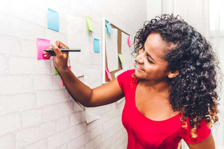 Beautiful creative business african american black woman planning and thinking over the project...