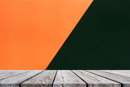 Wood table top on orange and black for halloween backgroundの写真素材