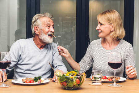 Senior couple enjoy eating  healthy breakfast together in the kitchen.Retirement couple conceptの写真素材
