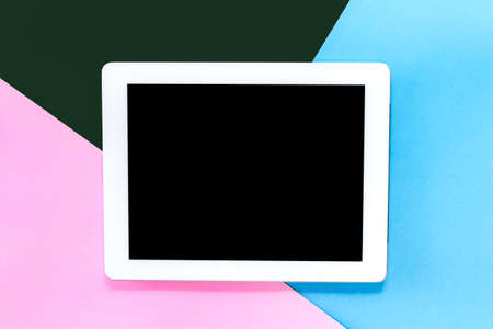 Top view of mockup digital tablet with blank screen on blue and pink pastel background.technology and communication concept.Flat layの写真素材