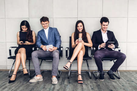 Group of business sitting relax use technology together of smartphone and tablet computer checking...