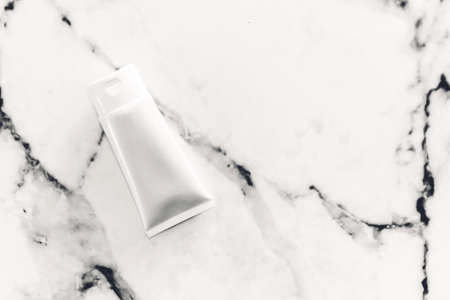 Cosmetic bottle skin care products on white marble background.flat layの写真素材