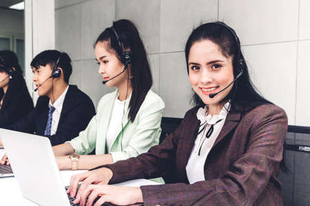 Beautiful businesswoman customer support services working with headset and computer at call centerの写真素材