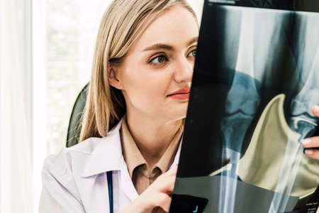 Female doctor looking at x-ray photo in hospital.healthcare and medicineの写真素材