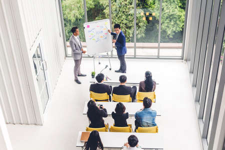 Businessman standing in front of group of people in consulting meeting conference seminar at hall or seminar room.presentation and coaching conceptの写真素材