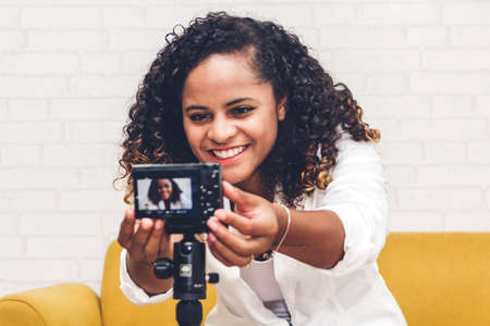 African american woman blogger in front of camera recording herself.social media concept