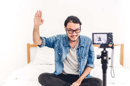 Asia man blogger in front of camera recording herself.social media conceptの写真素材
