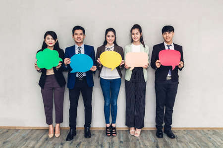 Group of business people holding a speech bubble icon