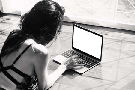 Happy woman relaxing and using digital laptop computer at home.woman checking social apps and...