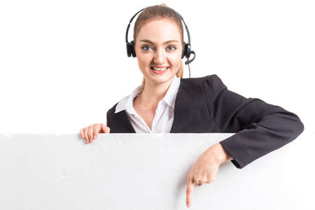 Beautiful businesswoman customer support services working with headset white blank billboard...