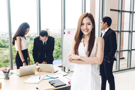 Businesswoman standing in front of group of casual business discussing and working with laptop computer.creative business people planning and brainstorm in modern workloft.Teamwork conceptの写真素材