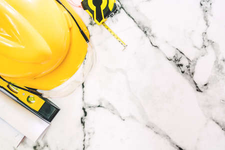Construction tools with helmet safety on white marble backgroundの写真素材