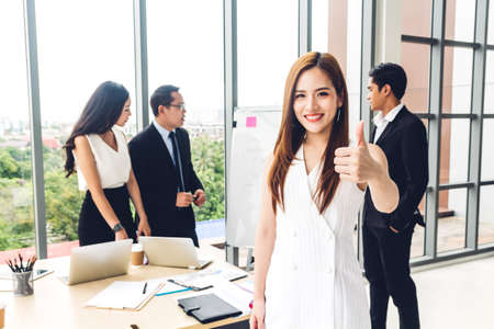 Businesswoman standing in front of group of casual business discussing and working with laptop computer.creative business people planning and brainstorm in modern workloft.Teamworkの写真素材