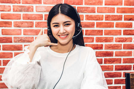 Beautiful businesswoman customer support services working with headset and computer at call centerの写真素材