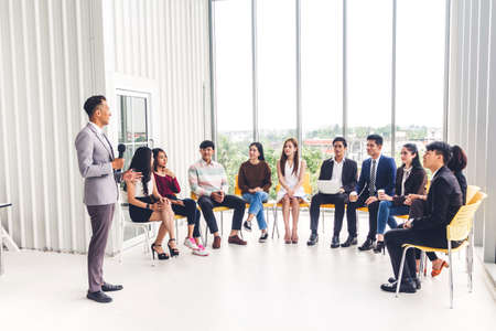 Businessman standing in front of group of people in consulting meeting conference seminar at hall or seminar room.presentation and coaching conceptの写真素材