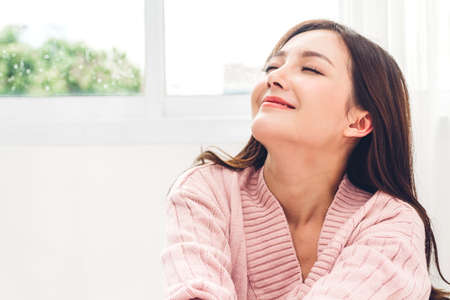 Woman feeling happy and relaxed breathing fresh air at morningの写真素材