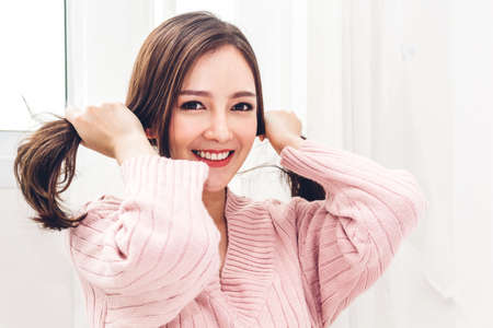 Portrait of happy smile asia woman enjoy and relax on the bed in bedroom at home.asian beauty
