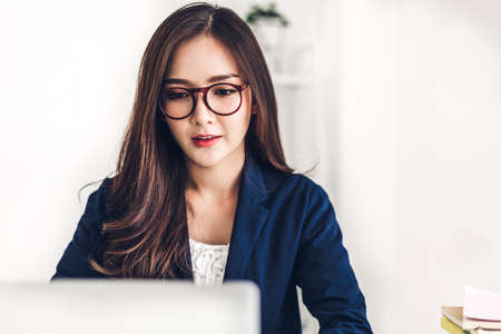 Businesswoman sitting and working with laptop computer.creative business people planning in her...