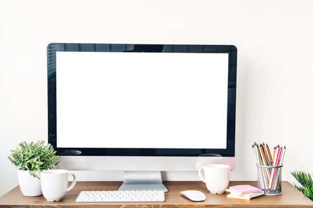 Desktop computer with white mockup blank screens on the tableの写真素材