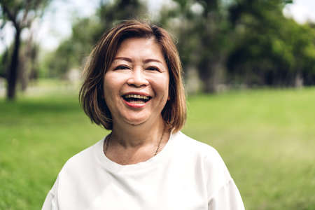Portrait of happy senior adult elderly asia women smiling and looking at camera in the park.Retirement conceptの写真素材