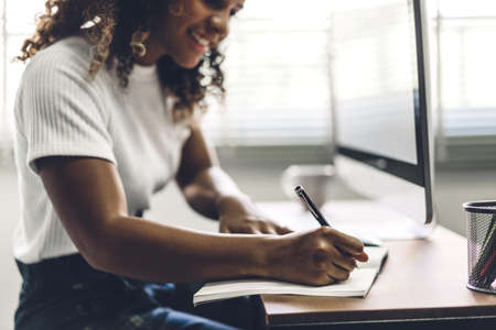 African american black woman working with laptop computer.creative business people planning and using pen in modern work loftの写真素材