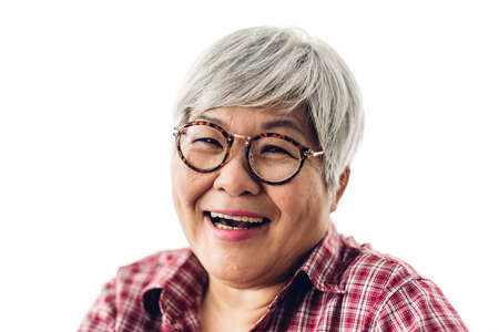 Portrait of happy senior adult elderly asia women smiling and looking at camera on white background.Retirement conceptの写真素材