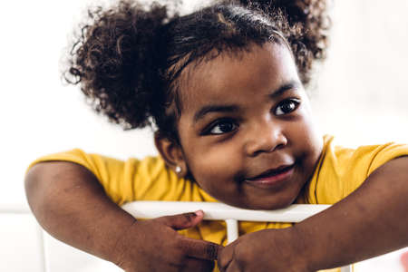 Portrait of happy smiling little child african american girlの写真素材