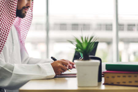 Arabic businessman working with laptop computer.creative arab business people planning at modern...