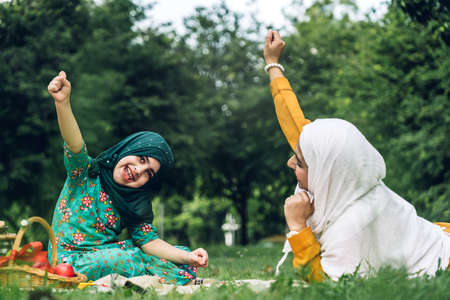 Portrait of happy lovely family arabic muslim mother and little muslim girls child with hijab dress...