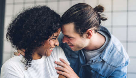 Young happy couple smile and have fun together at home