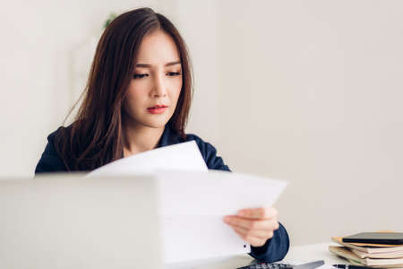 Businesswoman sitting and working with laptop computer.creative business people planning in her workstation at modern work loftの写真素材