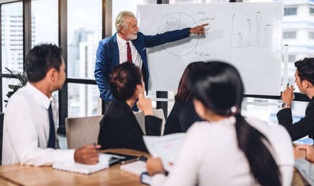 Group of professional business meeting and discussing strategy with new startup project.Creative business people planning and brainstorm with document report in modern workloft.Teamwork conceptの写真素材
