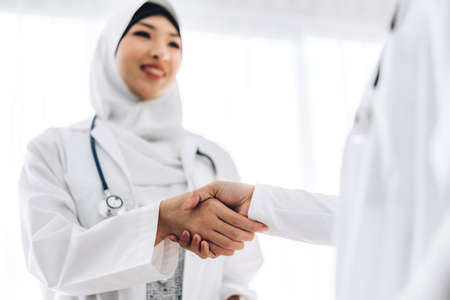 Success of handshake two muslim asian woman doctor in hospital.healthcare and medicineの写真素材