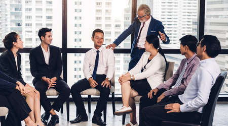Group of professional business meeting and discussing strategy with new startup project.Creative business people planning and brainstorm with document report in modern workloft.Teamwork conceptの写真素材
