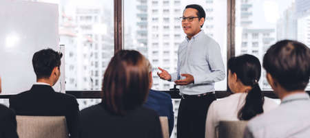 Businessman standing in front of group of people in consulting meeting conference seminar at hall or seminar room.presentation and coaching conceptの写真素材