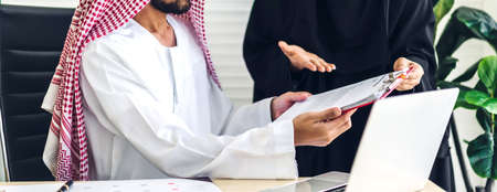 Successful of  two arabic business people working with laptop computer.creative arab people planning and brainstorm in modern office.Teamwork conceptの写真素材