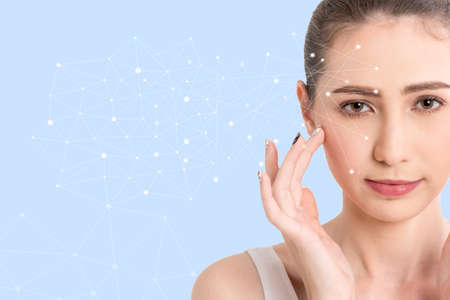 Beautiful woman beauty health care.beauty and spa with face tracking technology and science concept.perfect fresh skin isolated on blue backgroundの写真素材