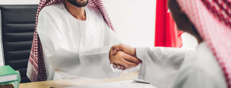 Successful of arab business partner handshake together in modern office.Partnership approval and thanks gesture conceptの写真素材