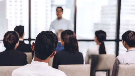 Businessman standing in front of group of people in consulting meeting conference seminar at hall or seminar room.presentation and coaching conceptの写真素材