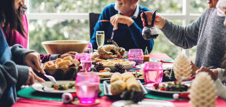 Portrait of happy big family celebrating having fun and lunch together enjoying spending time together at homeの写真素材