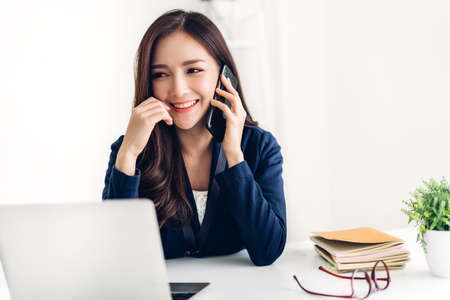 Businesswoman sitting and working with laptop computer.creative business people planning in her workstation at modern work loftの写真素材