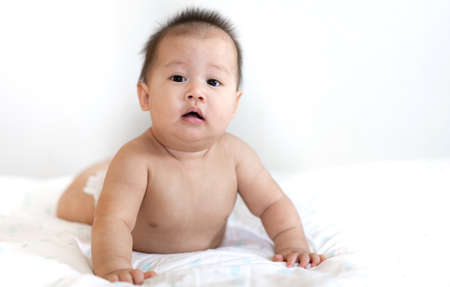 Portrait of happy asian smile baby relaxing on the bed