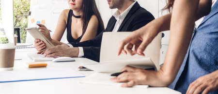 Group of professional business meeting and discussing strategy with new startup project.Creative business people planning and brainstorm with document report in modern workloft.Teamwork conceptの写真素材