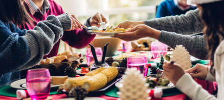 Portrait of happy big family celebrating having fun and lunch together enjoying spending time together at homeの写真素材