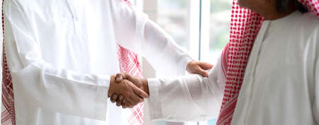 Successful of arab business partner handshake together in modern office.Partnership approval and thanks gesture conceptの写真素材