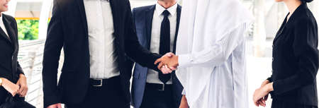 Successful businessmen handshake partner with arab businessmanの写真素材