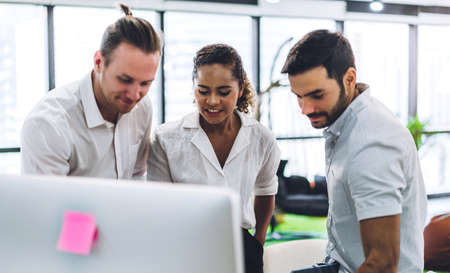 Group of professional business meeting and discussing strategy with new startup project.Creative business people planning and brainstorm with document report in modern workloft.Teamwork conceptの写真素材