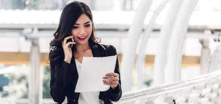 Businesswoman using smartphone.creative business people planning and working on cityの写真素材